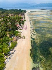 Wall Mural - Top down aerial view of a tropical beach and resorts on a small island