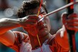 Focused male archer aiming at target with bow and arrow at competition. Modern sports photography.