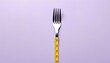 fork with measurement tape on color background