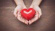 red heart in hands, donate or charity concept