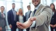 © CinimaticWorks - professional businessman welcoming new employee to his business team and company with hand forward in modern office