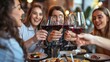 © CinimaticWorks - friends socializing and toasting wine at a restaurant pub with appetizers during happy hour having a great time together