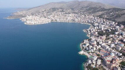 Wall Mural - Bird's eye view of Sarande, city in Albanian Riviera. Ionian Sea coastline.