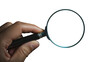 © Simon C - Hand holding a magnifying glass on transparent background, symbolizing search and investigation