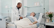 © SneakyPeakPoints/peopleimages.com - Consultation, healthcare and doctor with senior man in hospital after surgery, treatment or procedure. Discussion, checkup and African male medical worker talk to patient in clinic bed for diagnosis.