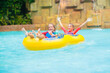 © famveldman - Kids on water slide. Family in aqua theme park.