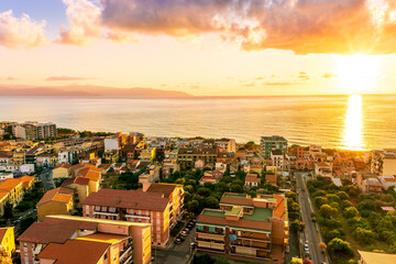 Wall Mural - panoramic summer travel view from a hill to  beautiful sea coast historical town with port, amazing ocean bay and gulf and beautiful mountains with scenic sunset on background.