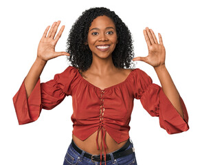 Wall Mural - African American woman in studio setting showing number ten with hands.