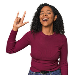 Wall Mural - African American woman in studio setting showing a horns gesture as a revolution concept.