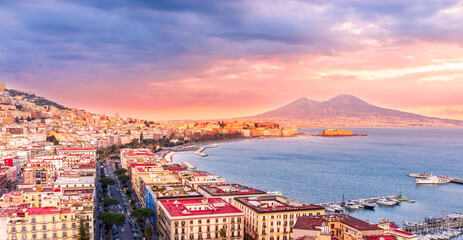 beautiful panorama of Naples city with amazing coast, sea port, streets and buildings and volcano Vesuvius with anazing sky on background