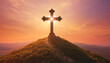 Large Christian cross on a hill against sunset background