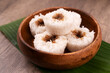 Close up of putu bambu or steamed rice flour cake with grated coconut and palm sugar filling