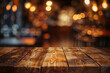 Rustic wooden tabletop with warm bokeh lights of a bar in the background. Evening social dining concept with copy space. High quality photo