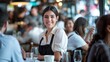 © Elmira - A woman is seated at a table in a restaurant, looking at a menu and waiting for her order
