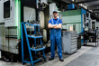 © Westend61 - Confident mature technician standing with arms crossed by machinery in modern industry