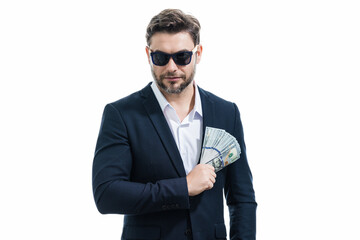 Business man hold money on white studio isolated background. Rich man in suit with money dollar bills. Successful businessman with dollar banknotes. Rich millionaire in suit holding money.