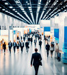 © Elba Cabrera - Blurred business people walking at a large trade fair