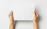 Fototapeta Mapy - Hands are holding a blank sheet of paper with a white background.