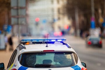 Poster - Law enforcement car with turned on police lights stoped the traffic to ensure public safety in public events