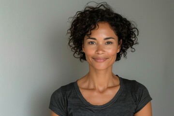 Sticker - A woman with curly hair is smiling and wearing a black shirt