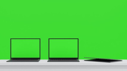 Wall Mural - three laptop on white table open to show green screen display one by one on green background, applic