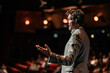 © Emanuel - Inspirational speaker wearing a microphone headset, delivering a lecture on stage