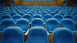 Empty blue seats in an auditorium.