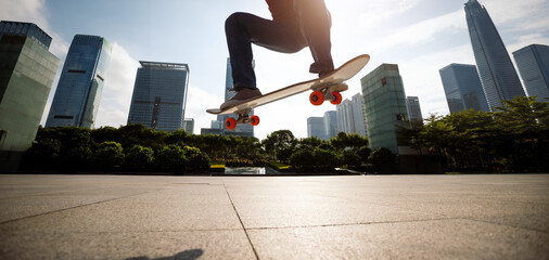 Asian woman skateboarder skateboarding in modern city