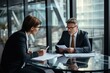 © lolya1988 - A group of business people in blazers are sharing papers at an event