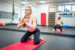 © dtatiana - Young woman works out in the gym performing an exercise