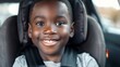 boy 6 years smiling old sitting in car seats in the car, Black skin, frontal plane, Look at the camera