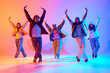 © master1305 - Dynamic image of young people, men and women in casual clothes dancing contemp against gradient studio background in neon light. Concept of modern dance style, hobby, active lifestyle, youth culture
