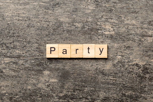 PARTY word written on wood block. PARTY text on cement table for your desing, concept