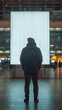© PLATİNUM - Man Standing at the Airport in Front of a Blank Advertisement Billboard During Evening, mockup