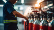 Engineer worker checking fire extinguisher. Inspection extinguishers in factory or industry.
