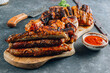 Various grill and bbq meat : chicken legs, pork steaks, sausage and sauce