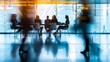 © korisbo - A blurred background of business people in a office meeting room, sitting around the table and discussing ideas. The focus is on their silhouettes against the glass wall behind them