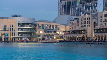 Wall Mural - The Dancing Fountain of Dubai and lake day to night timelapse at dusk in Dubai, UAE.