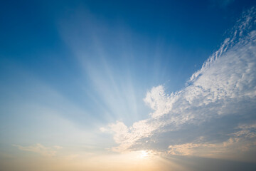 sunset or sun rise sky with rays of  light shining clouds and sky background and texture