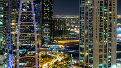 Wall Mural - Buildings of Jumeirah Lakes Towers with traffic on the road night timelapse.