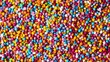 Colorful candy sprinkles background. Close up of many different colored round sugar coated chocolate candies. Directly above.