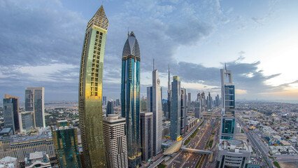 Wall Mural - Dubai downtown architecture day to night timelapse. Top view over Sheikh Zayed road with illuminated skyscrapers and traffic.