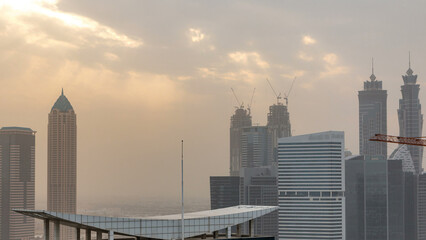 Wall Mural - Dubai business bay towers at sunset aerial timelapse.