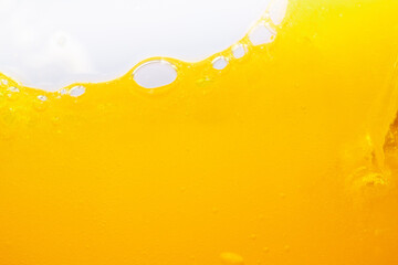 Wall Mural - Close up bright orange juice splash texture for health and nature waves, Beautiful waves curve and little bubbles smooth for garphic design and background