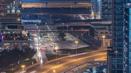 Wall Mural - Birds eye view of Dubai skyline timelapse and rush hour traffic in downtown at night