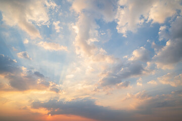 Wall Mural - sunset or sun rise sky with rays of light shining clouds and sky background and texture