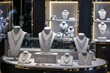 lavish jewelry stand with sparkling necklaces, boutique setting
