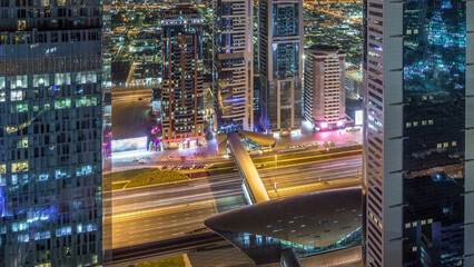 Wall Mural - Skyline view of the buildings of Sheikh Zayed Road and DIFC night timelapse in Dubai, UAE.