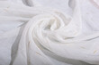 The fabric is white, rolled up by the inversion of the waves. Folds of the curtain in the form of a flower.