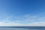 Fototapeta Na sufit - Beautiful blue sky over the sea with translucent, white, Cirrus clouds